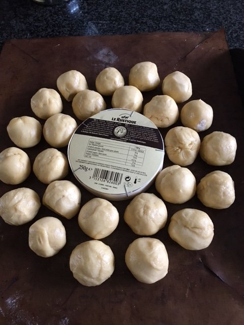 brioche buns tear and share before final prove on a baking tray with camembert cheese in the middle