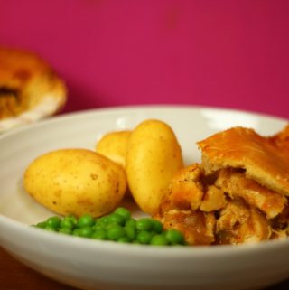 chicken curry pie with potatoes and peas in a bowl