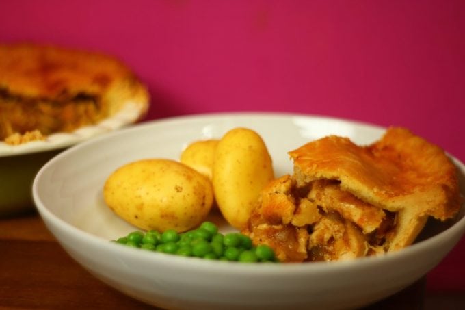 chicken curry pie with potatoes and peas in a bowl