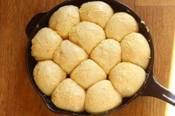 garlic rolls in a skillet ready for the oven