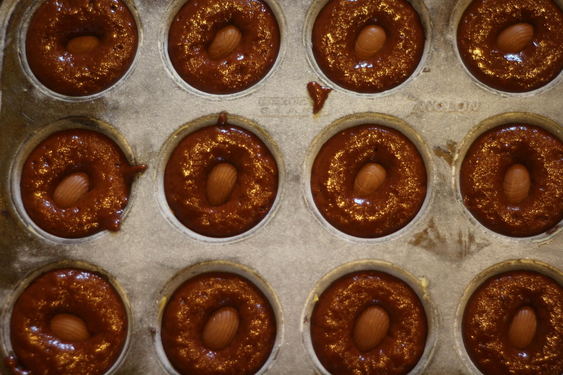 Chocolate Muffins pre oven with Galaxy Caramel Eggs.