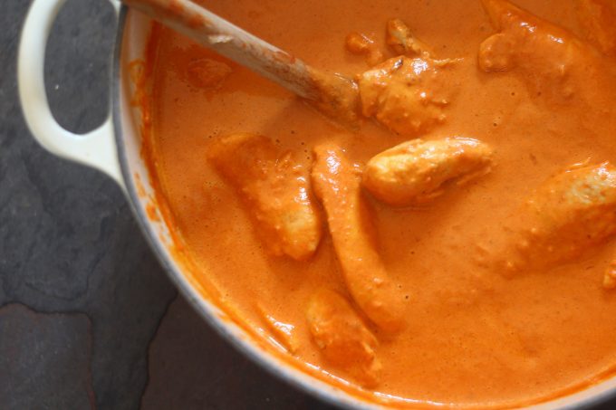 butter chicken simmering in a pan