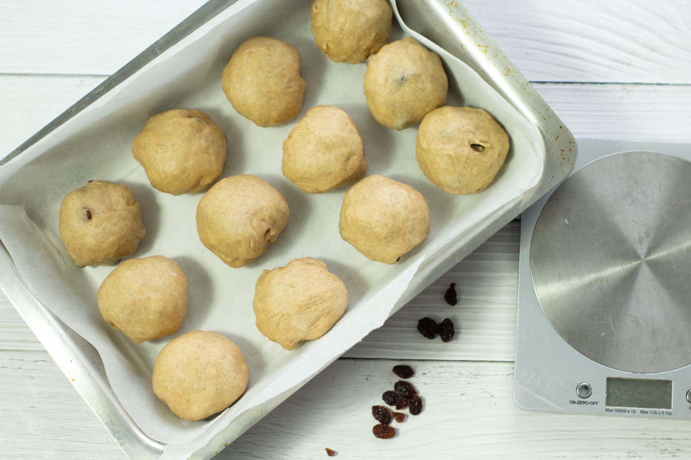 hot cross buns in a lined baking tray