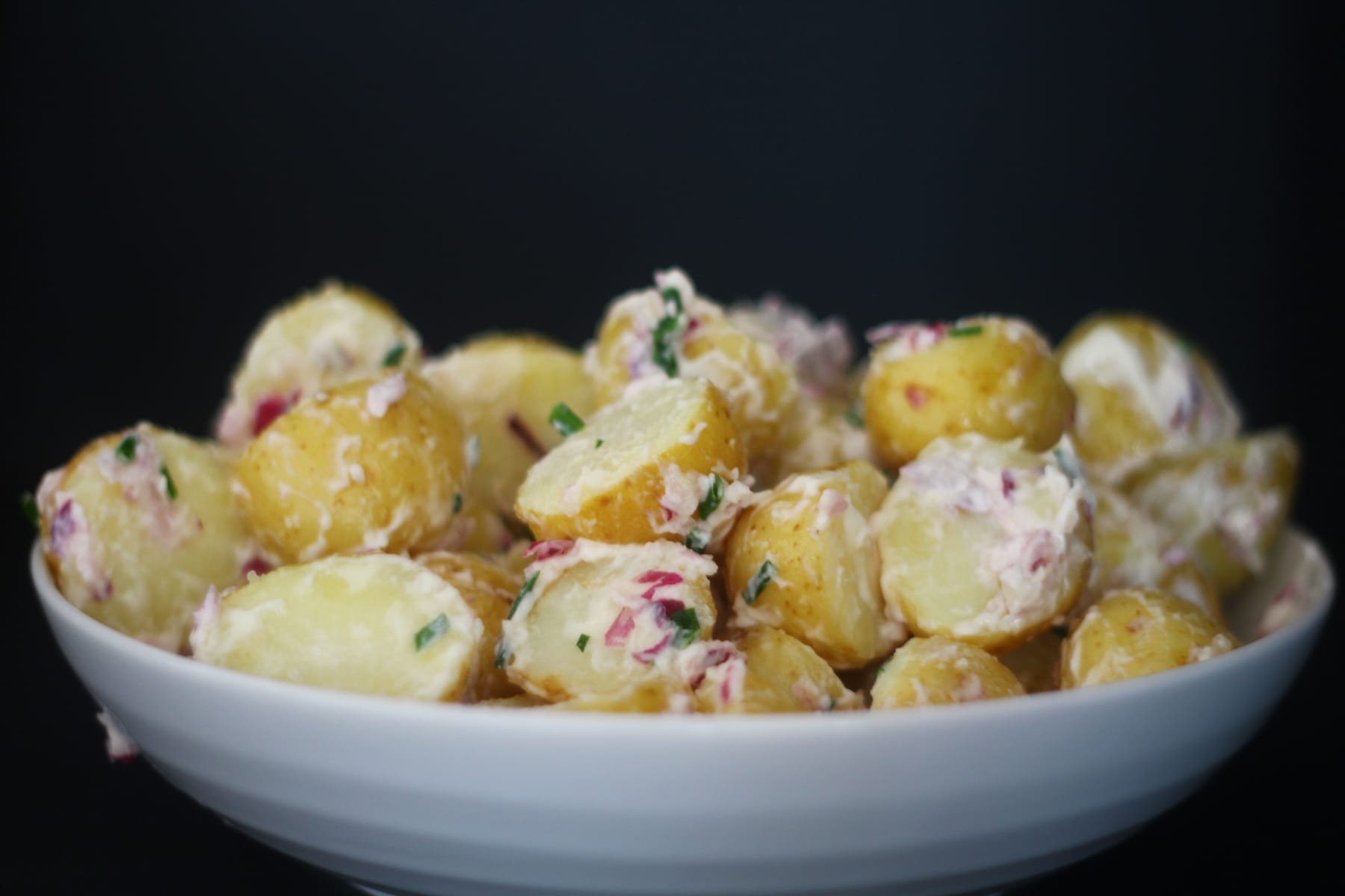 Potato Salad with chives Potato Salad with a Mayo Dresssing, Red Onion and Chives.