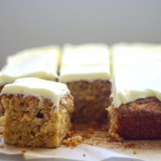 carrot tray bake with cream cheese icing cut into squares