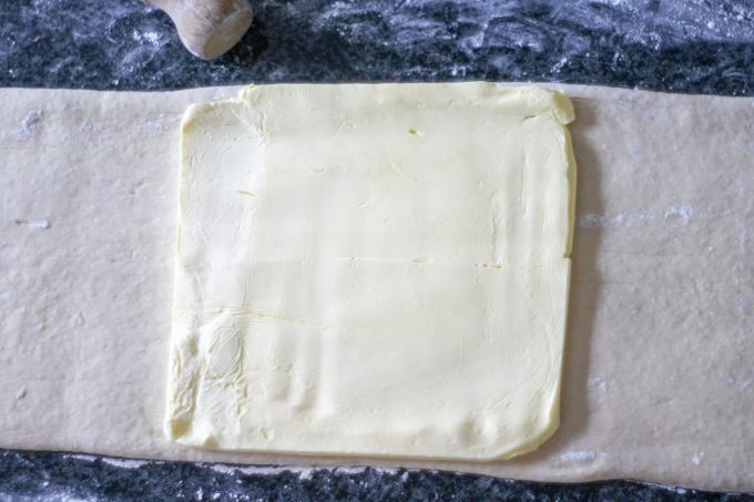 Chilled butter placed on the pain au chocolat dough Chilled butter placed on the pain au chocolat dough