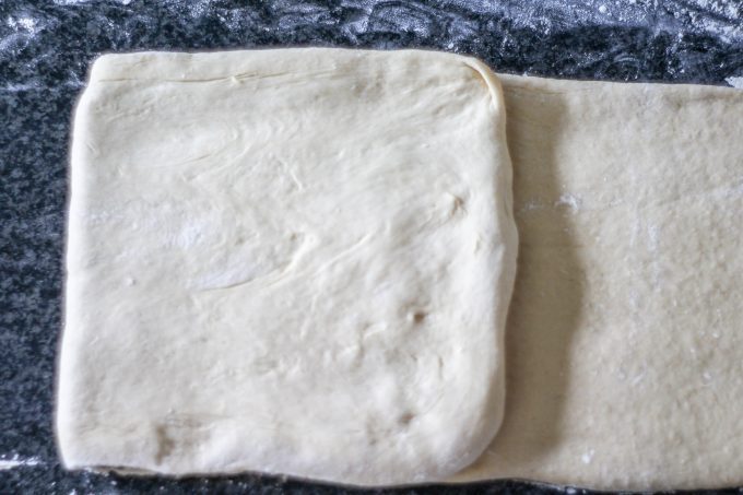 First fold over the butter for pain au chocolat dough First fold over the butter for pain au chocolat dough