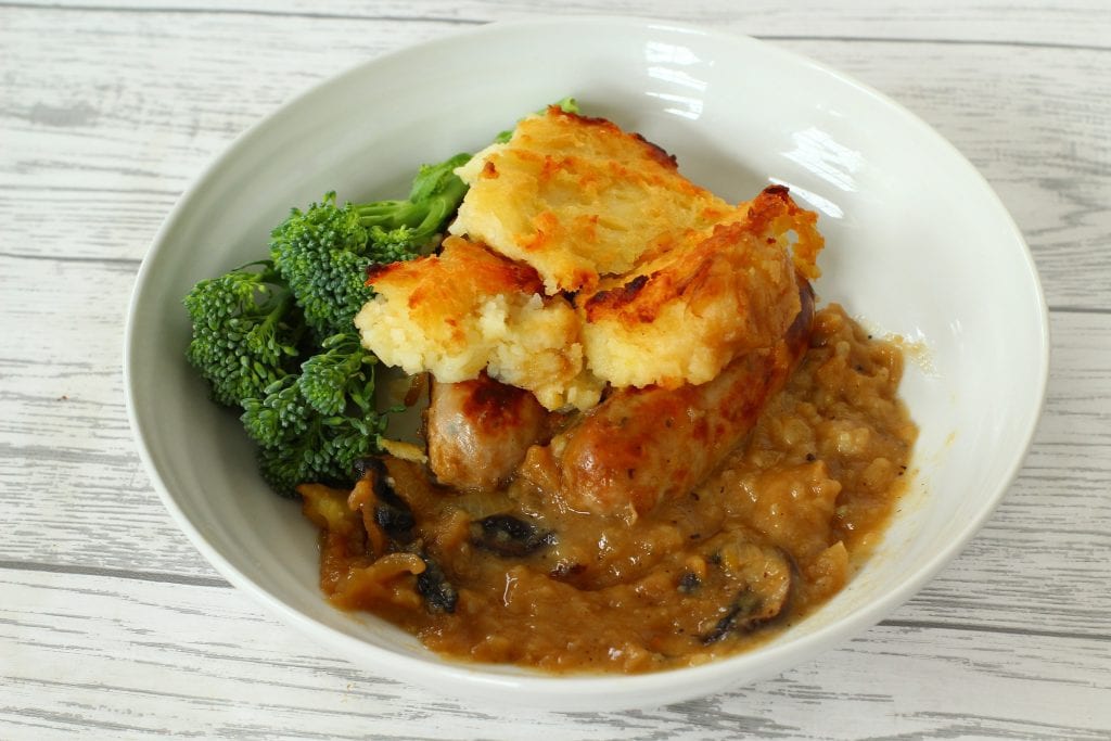 Sausages, onions, mushrooms and gravy bake Sausage Bake with mushroom, onion, gravy and a mashed potato topping