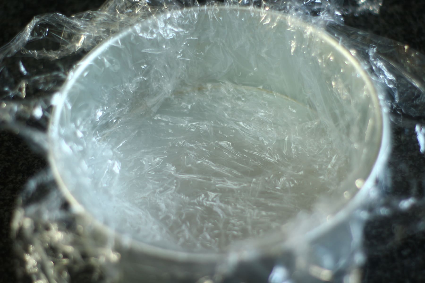cling film cross for ice cream cake cling film cross in a cake tin ready for the ice cream filling