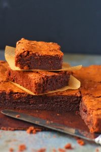 easy chocolate brownies pin pin for chocolate brownies cut into squares and stacked on top of each other with a knife near by