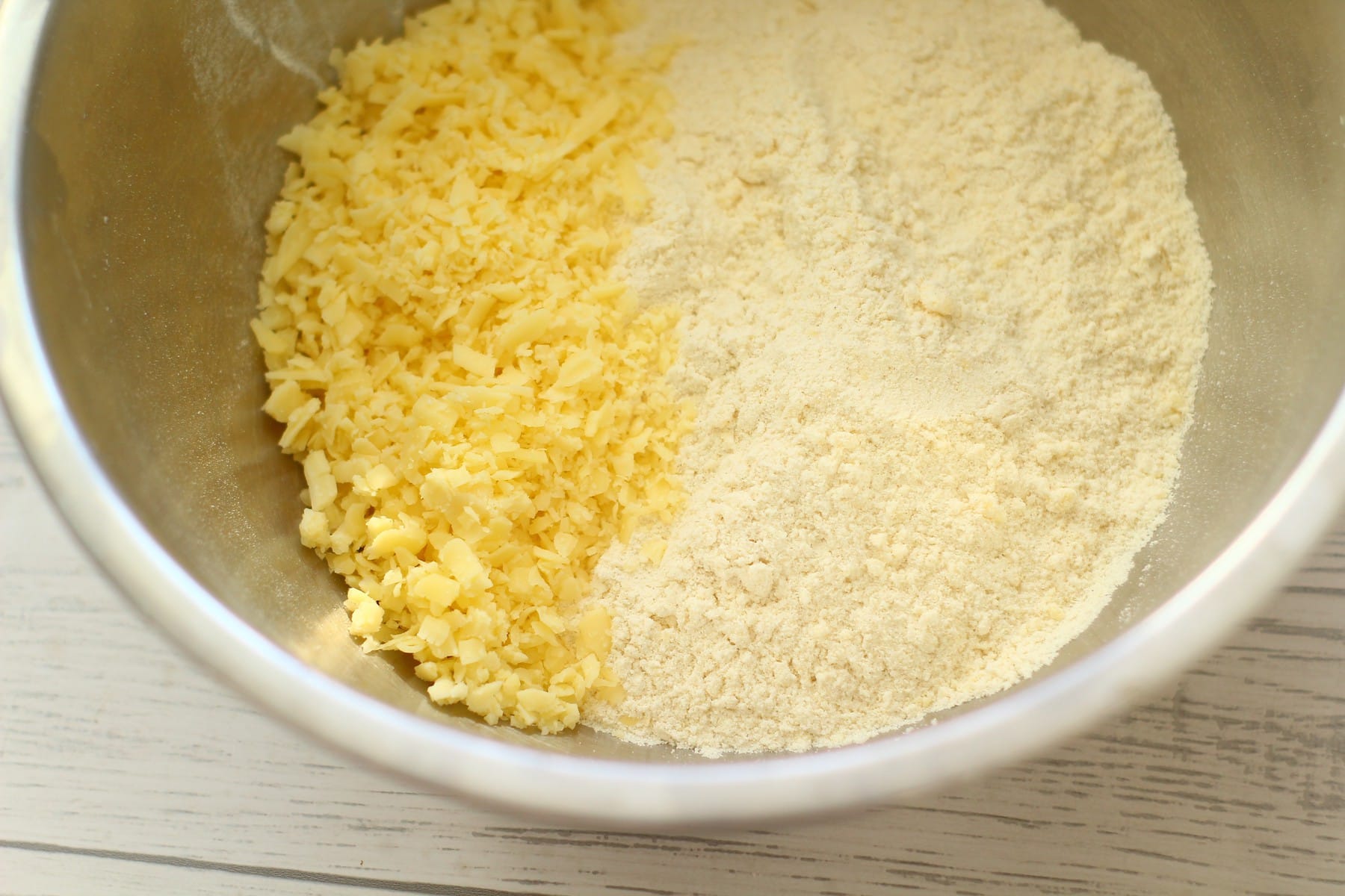 Cheese Scone Mixture cheese and scone breadcrumbs ready to be mixed in a bowl.