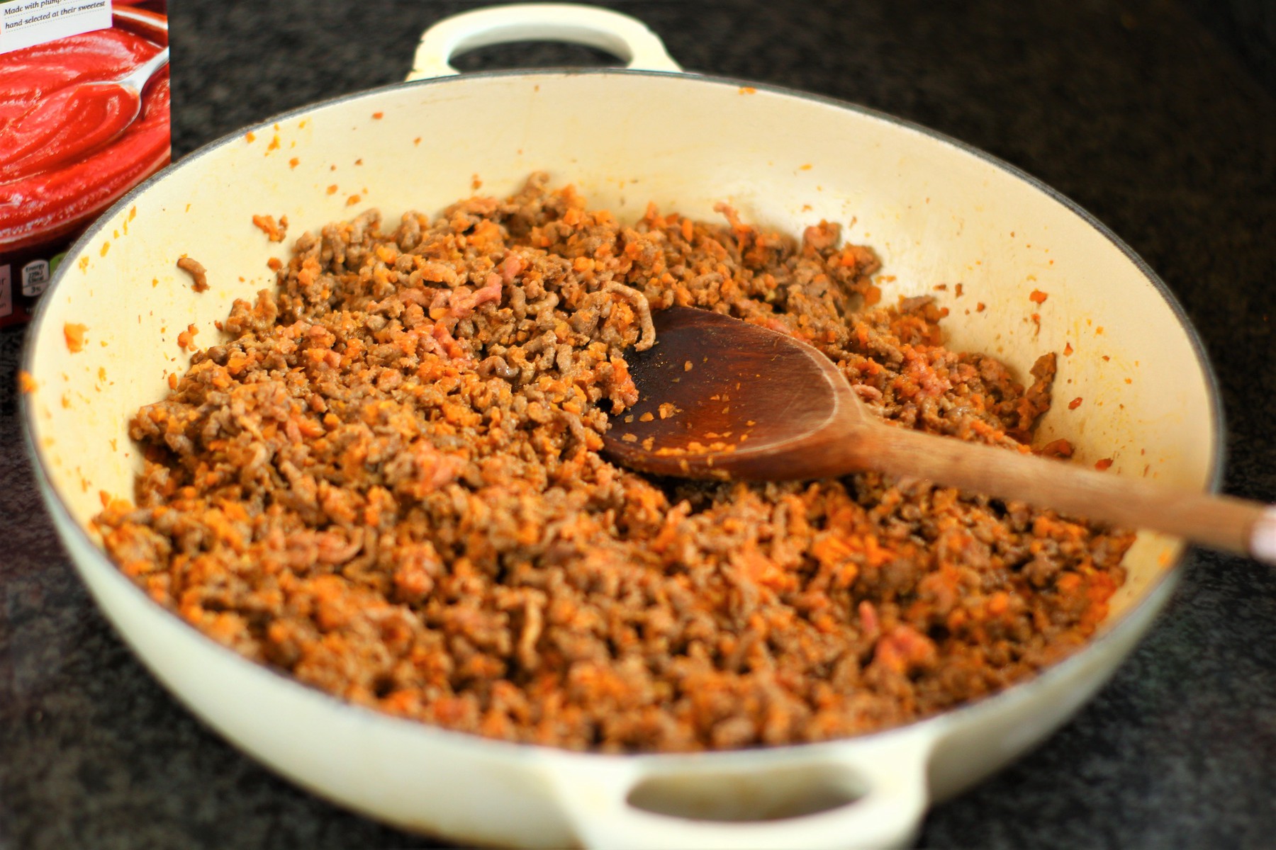 spaghetti bolognese mince carrot and minced beef in a large frying pan