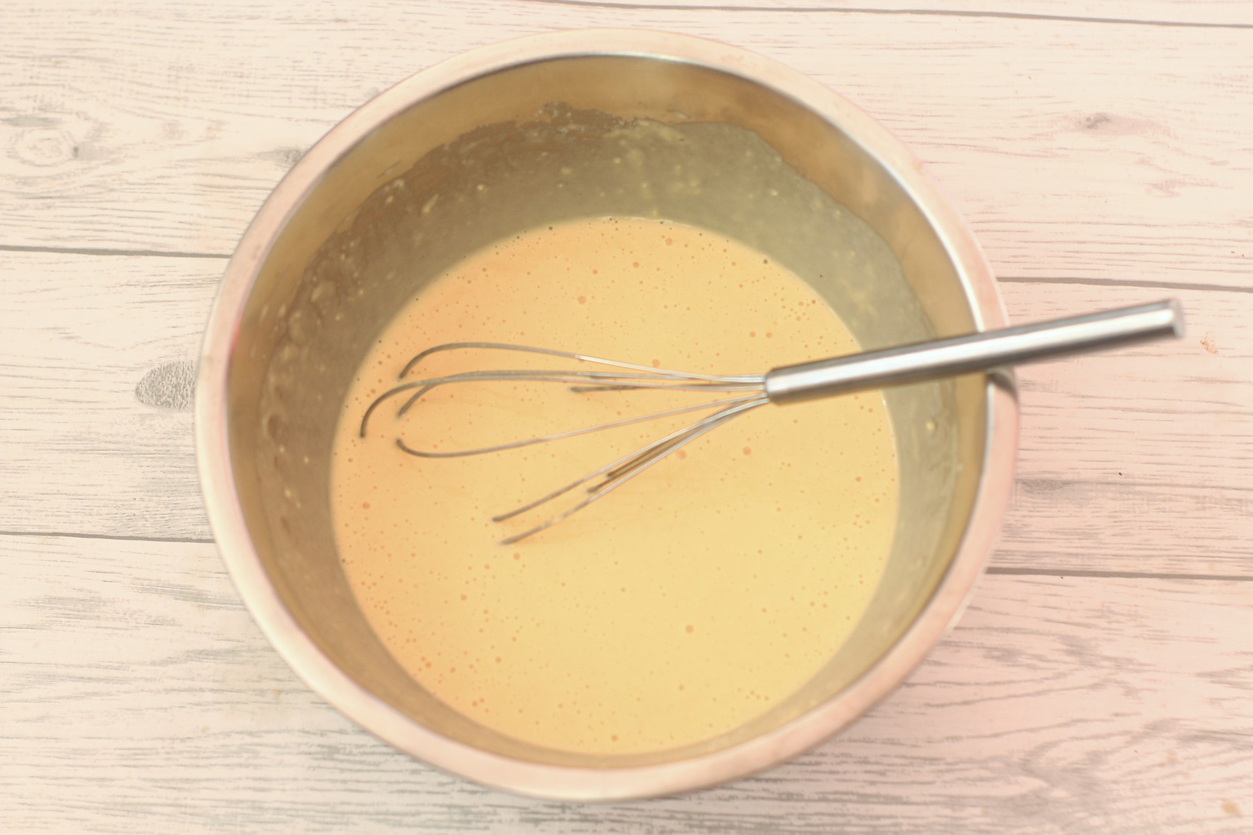 yorkshire pudding batter mix in a bowl with a whisk