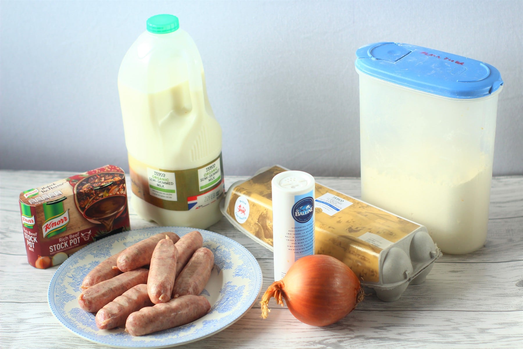 sausages on a plate, onion, salt, stock pots, eggs, flour, milk