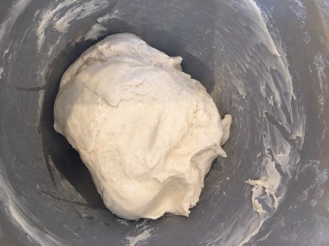white bread dough in a mixing bowl