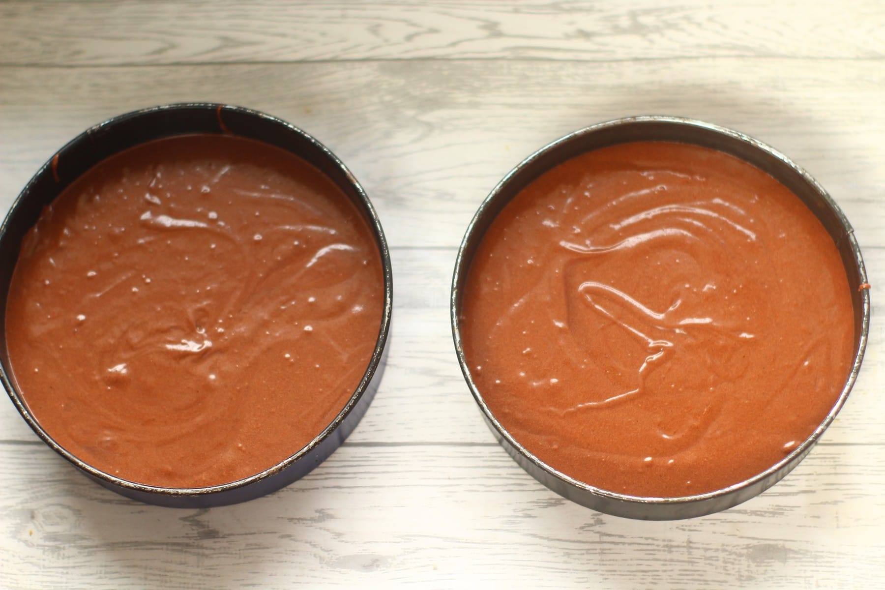 chocolate cake batter chocolate cake batter in baking tins