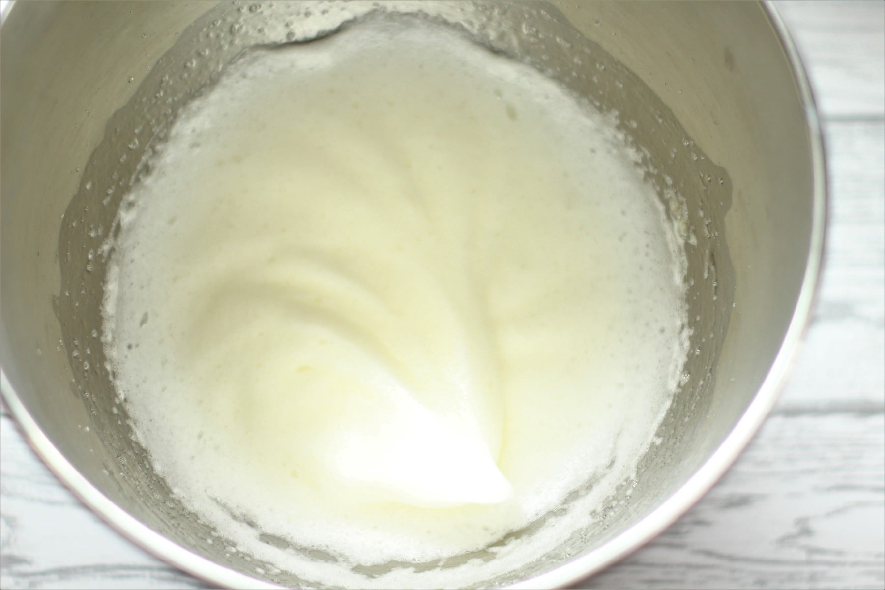 First whisk of egg whites in a mixing bowl