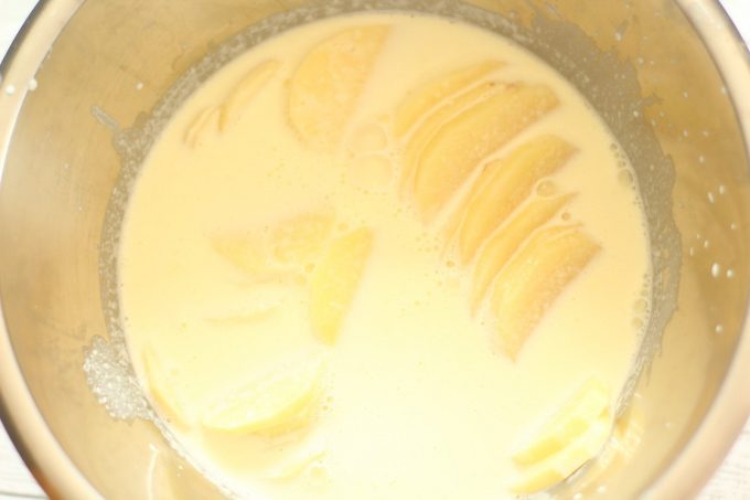 Sliced potatoes in cream in a bowl