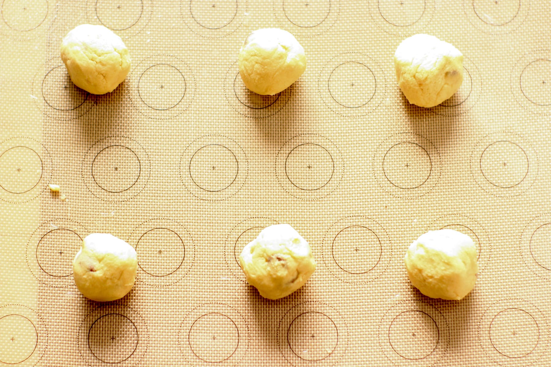 peanut butter chocolate chip cookie balls on a baking tray
