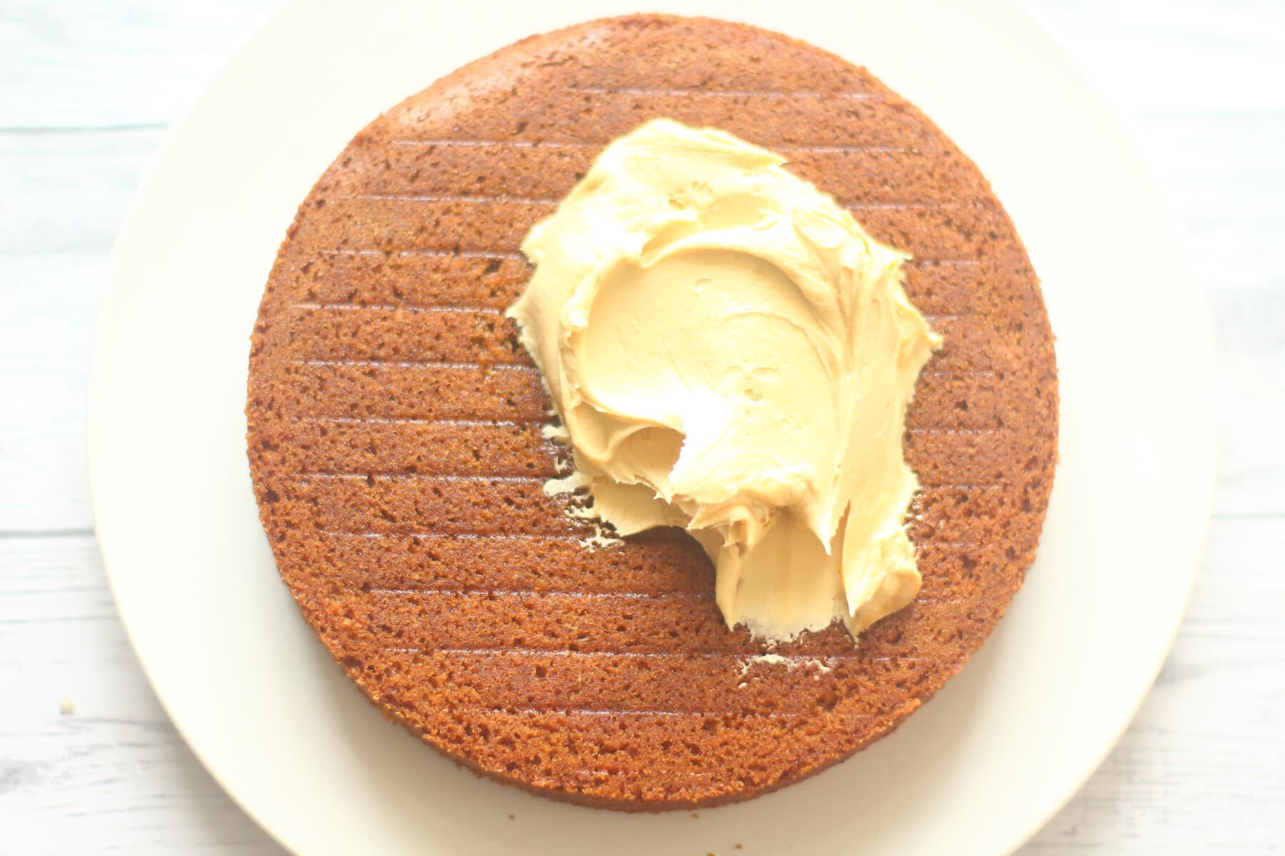 coffee icing dolloped on a cake