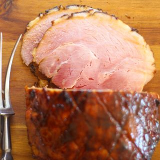 sliced gammon on a wooden chopping board