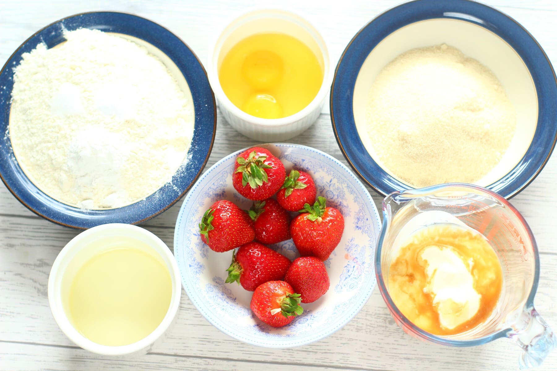 strawberries, flour, sugar,oil, milk, vanilla extract, baking powder, salt, eggs