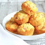 savoury muffins piled high on top of each other in a white bowl