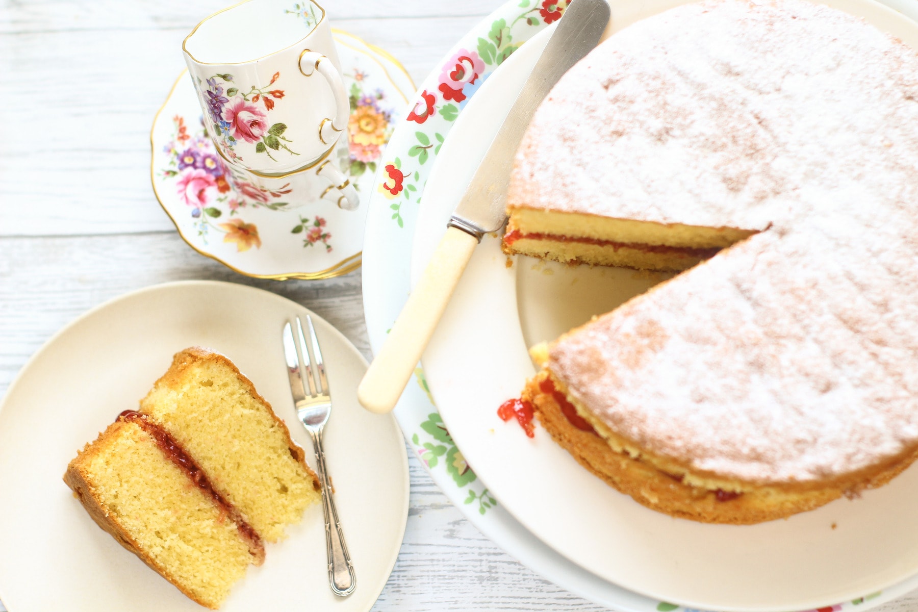 vicoria sponge cake with a slice of cake on a plate with a cake fork