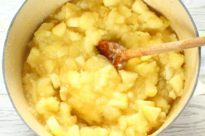 stewed apples in a saucepan with a wooden spoon