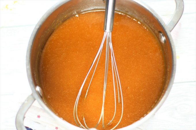 toffee sauce in a saucepan with a whisk