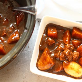 slow cooker beef casserole in a bowl with vegetables