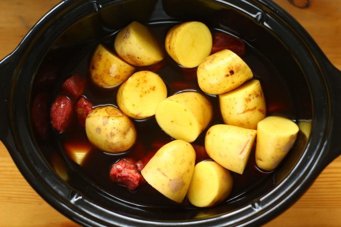 beef casserole ingredients in the slow cooker bowl