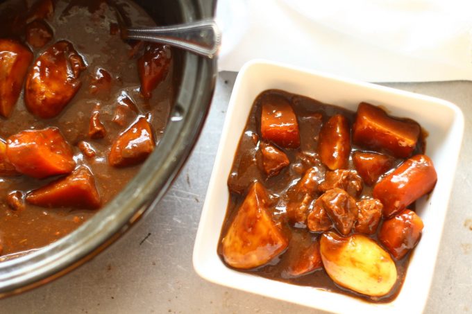 slow cooker beef casserole in a bowl with vegetables