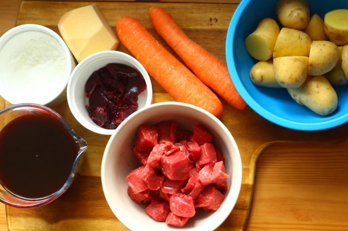 beef, beef stock, carrots, potatoes, cornflour, redcurrant jelly on a wooden board