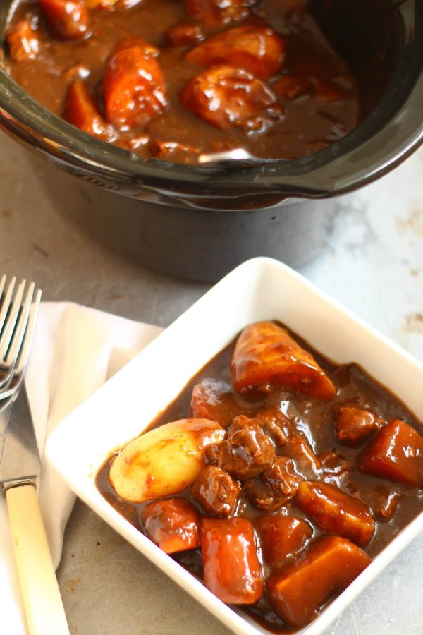 slow cooker beef casserole in a bowl with vegetables