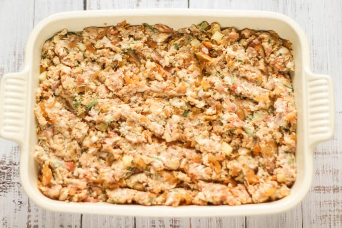 raw pork stuffing in a roasting dish