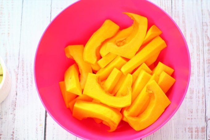 raw butternut squash slices in a bowl
