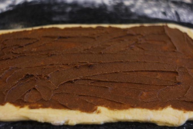 sugar and cinnamon paste spread over danish pastry dough