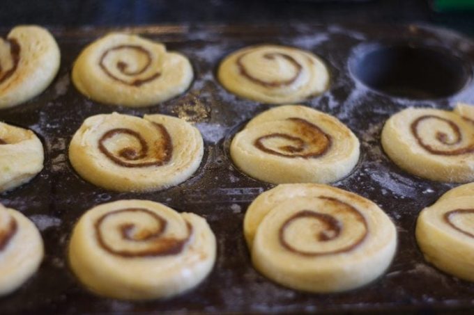 danish cinnamon rolls at the end of the final prove in their muffin tray