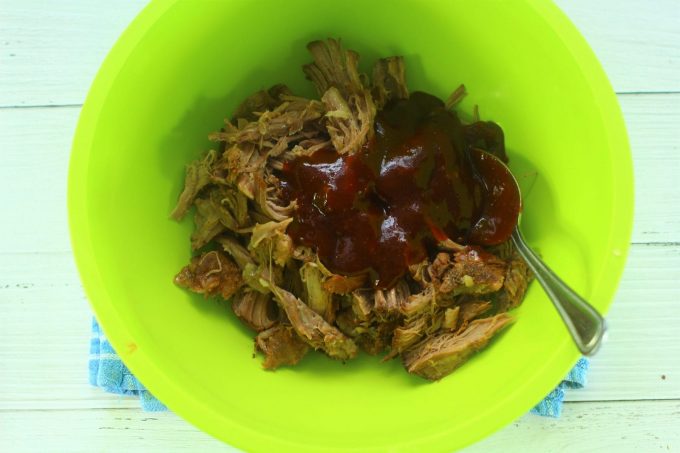 shredded pork in a bowl with bbq sauce