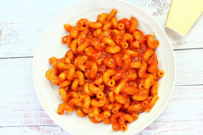 quick and easy tomato pasta in a bowl with some parmesan cheese near by.