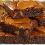 chocolate orange brownie squares piled on top of each other in a small tower