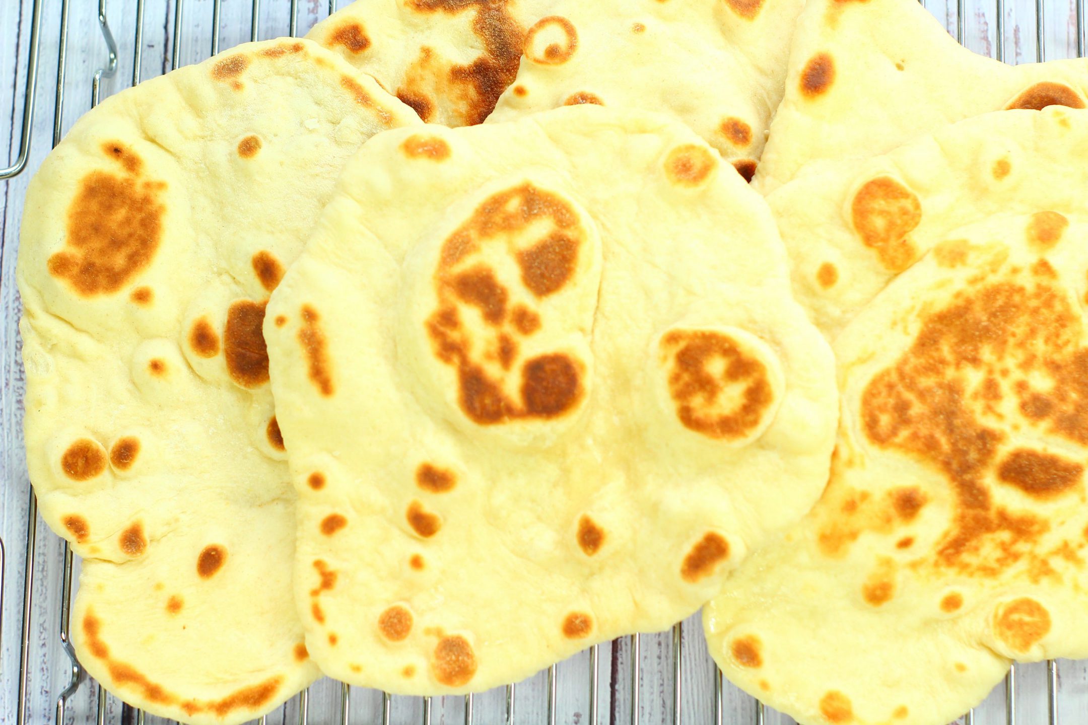 naan breads piled together on a wire rack