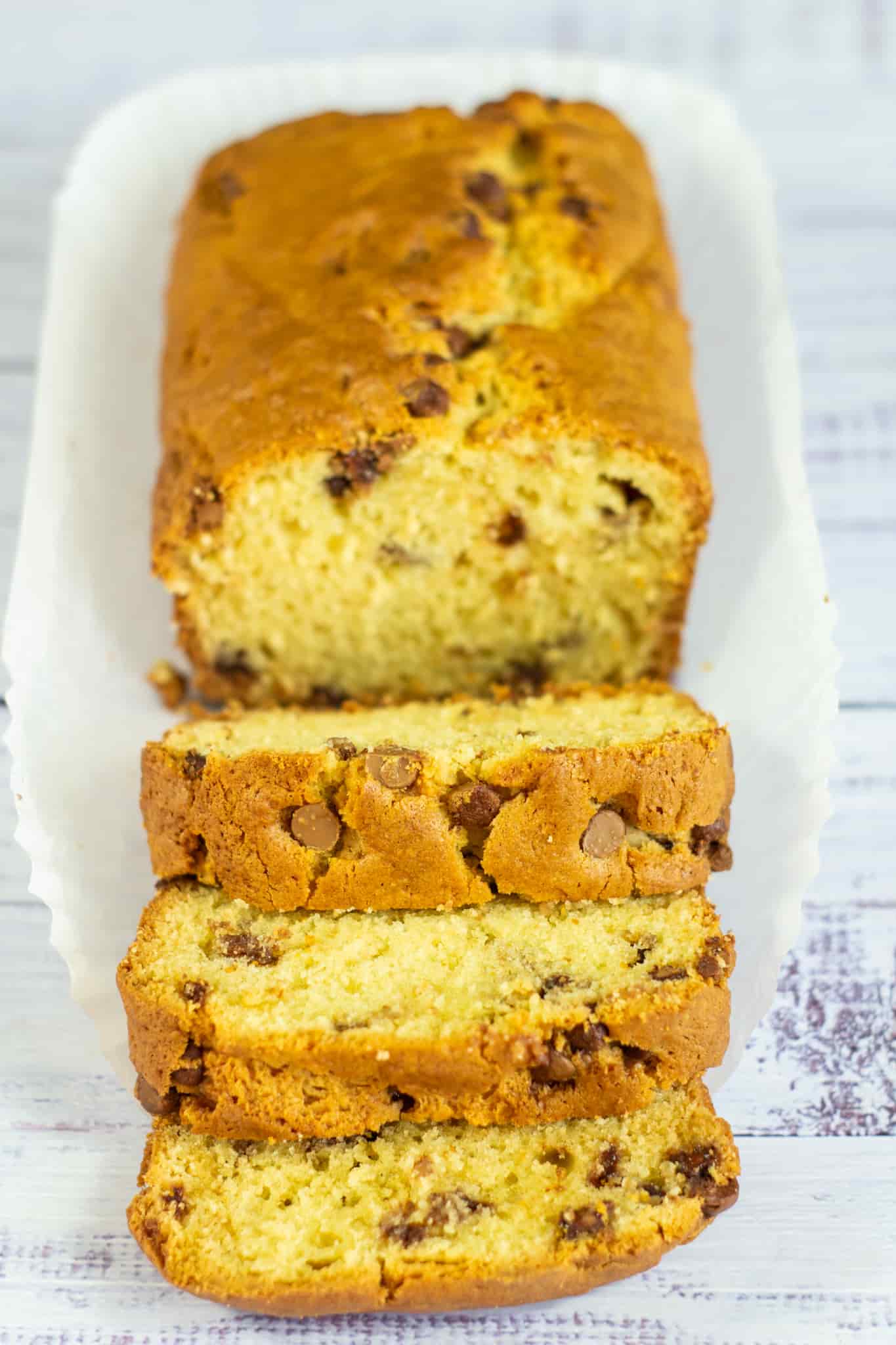 chocolate chip loaf cake sliced on a paper liner