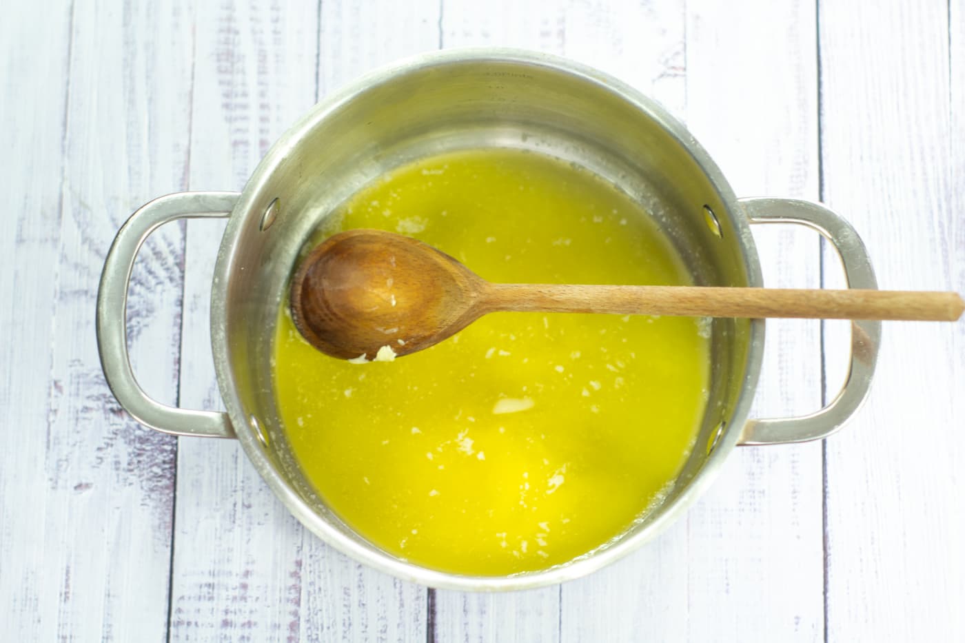 melted butter in a saucepan with a wooden spoon