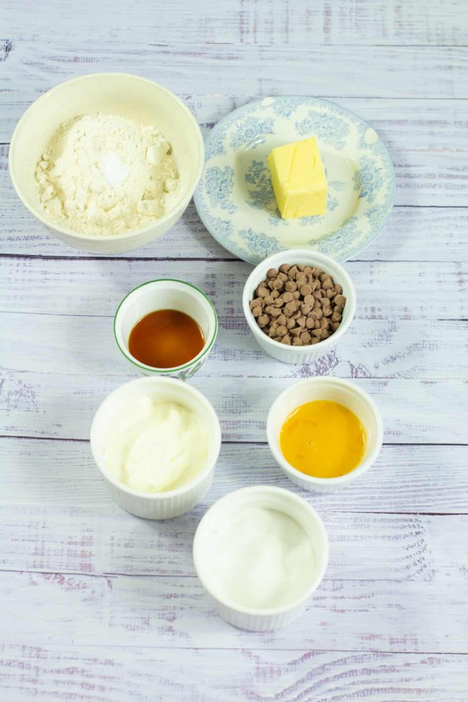 flour, sour cream, eggs, chocolate chips, vanilla extract, sugar and melted butter in small bowls