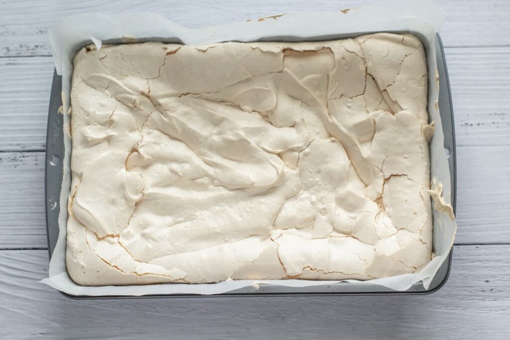 baked meringue roulade in a baking tin